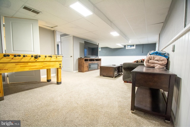 playroom featuring carpet flooring and a paneled ceiling