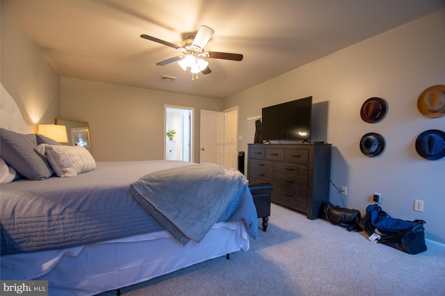 bedroom featuring light colored carpet and a ceiling fan