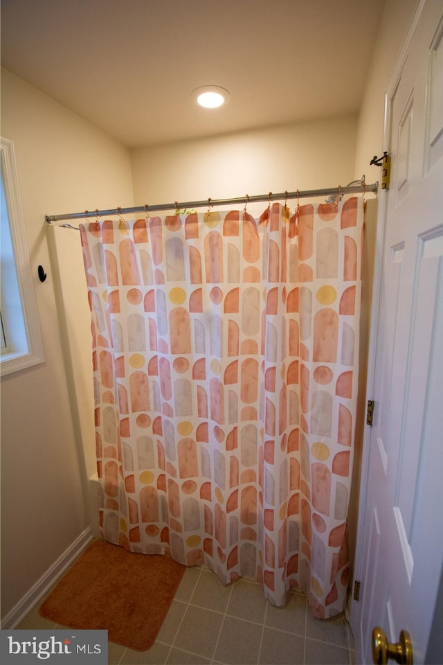 full bath featuring tile patterned floors and a shower with shower curtain