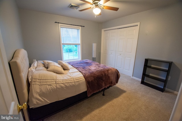 carpeted bedroom with a closet, a ceiling fan, and baseboards