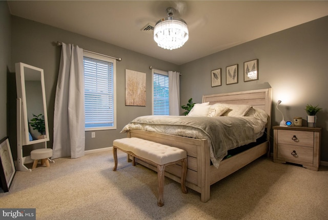 bedroom featuring carpet flooring, a chandelier, and baseboards