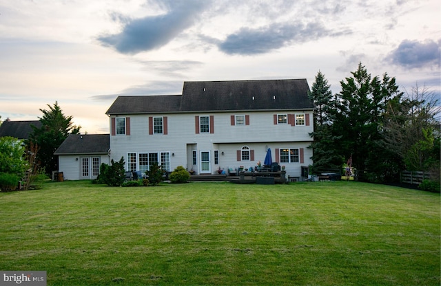 view of front of home featuring a front yard, outdoor lounge area, and french doors