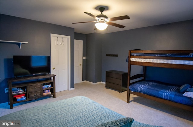 bedroom with carpet floors, a ceiling fan, and baseboards