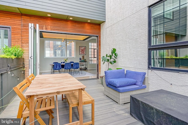 wooden terrace featuring outdoor dining area