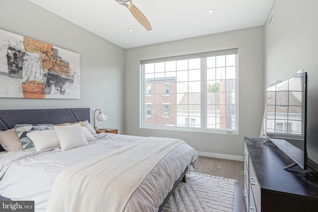 bedroom featuring wood finished floors, baseboards, recessed lighting, and a ceiling fan