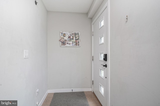 doorway featuring baseboards