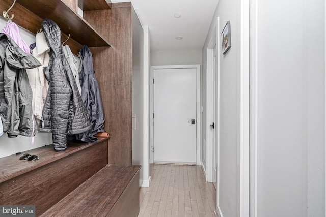 mudroom featuring light wood-style floors and baseboards