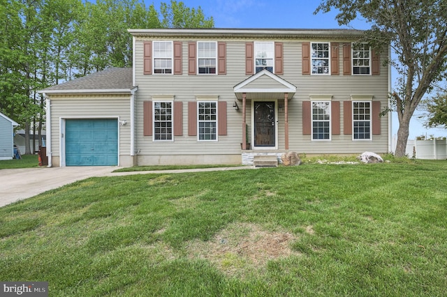 view of front of property with an attached garage, driveway, and a front yard