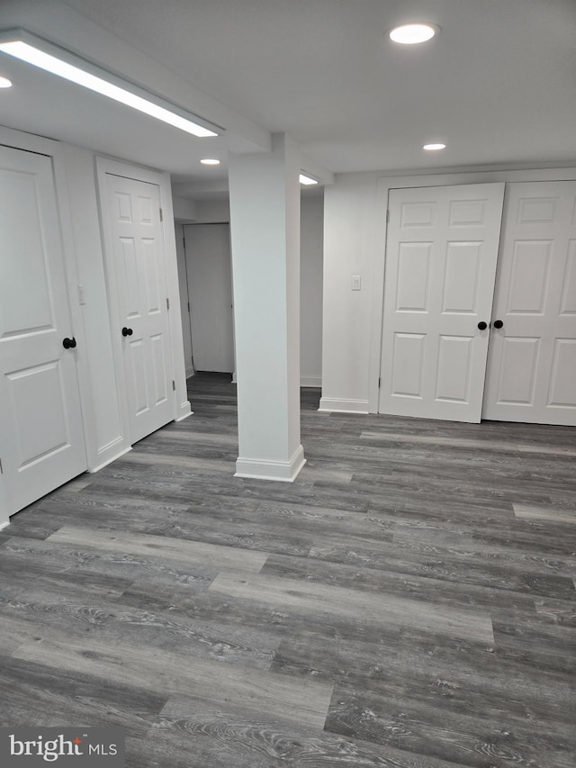 below grade area featuring recessed lighting, wood finished floors, and baseboards