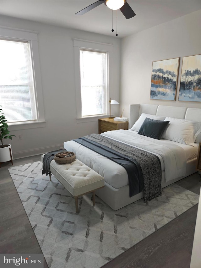 bedroom with multiple windows, a ceiling fan, and baseboards