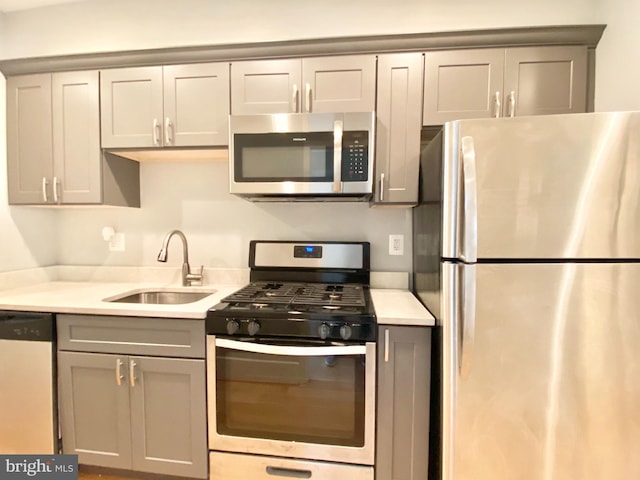1715 Montello Ave NE, Washington, DC 20002 - kitchen with appliances with stainless steel finishes, a sink, gray cabinets, and light countertops