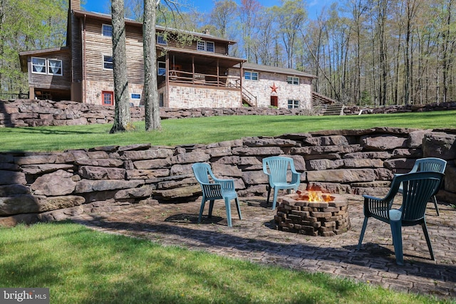 32 Black Bear Rd, Albrightsville, PA 18210 - rear view of property featuring an outdoor fire pit, a lawn, stairs, stone siding, and a patio area
