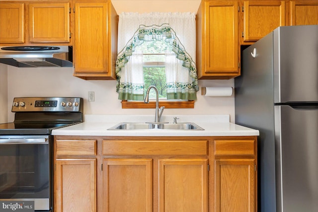 kitchen featuring stainless steel appliances, a sink, exhaust hood, and light countertops