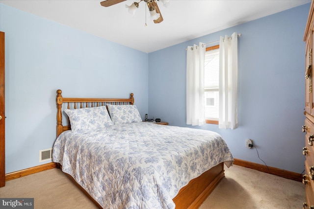 carpeted bedroom with baseboards and ceiling fan