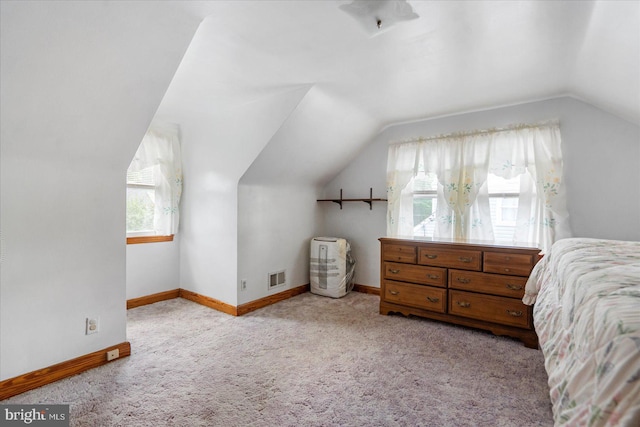 bedroom with lofted ceiling, carpet, and baseboards