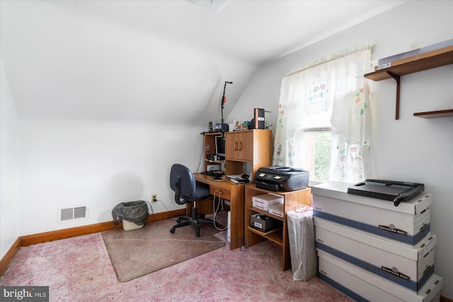carpeted home office featuring lofted ceiling and baseboards