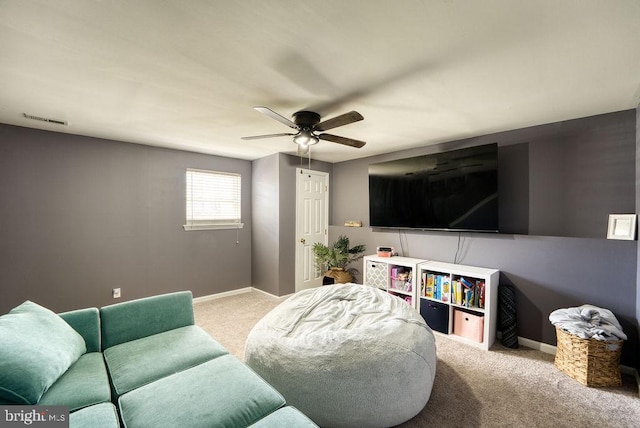 living room with carpet, a ceiling fan, and baseboards