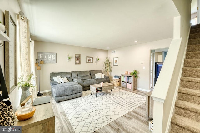 living area featuring wood finished floors, stairway, recessed lighting, and baseboards