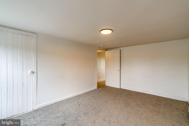 unfurnished bedroom with carpet floors and baseboards