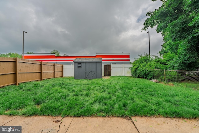 fenced backyard featuring a shed and an outdoor structure