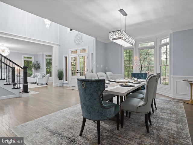 8197 Cottage Rose Ct, Fairfax Station, VA 22039 - dining area with stairway, wood finished floors, wainscoting, crown molding, and french doors