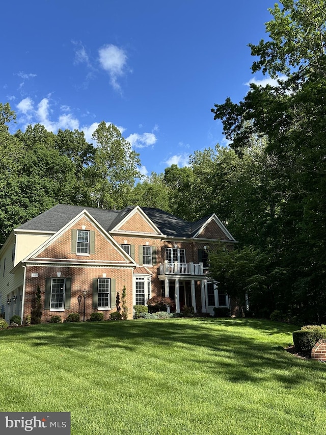 8197 Cottage Rose Ct, Fairfax Station, VA 22039 - view of front facade with a front yard, brick siding, and a balcony
