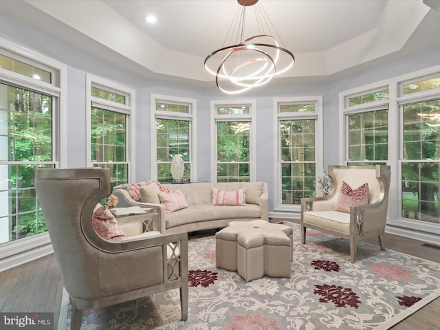8197 Cottage Rose Ct, Fairfax Station, VA 22039 - sunroom featuring a chandelier, a tray ceiling, and wood finished floors