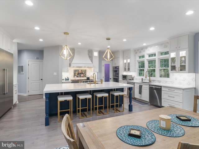 8197 Cottage Rose Ct, Fairfax Station, VA 22039 - kitchen featuring premium range hood, stainless steel appliances, backsplash, white cabinets, and recessed lighting