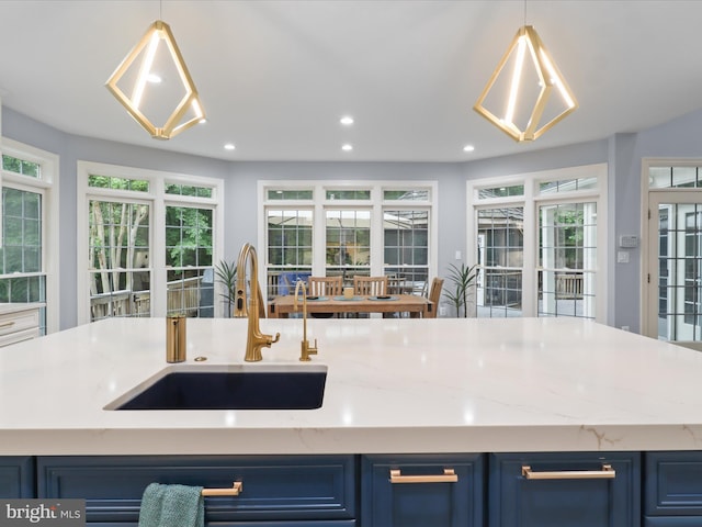 8197 Cottage Rose Ct, Fairfax Station, VA 22039 - kitchen with blue cabinets, a sink, recessed lighting, pendant lighting, and plenty of natural light