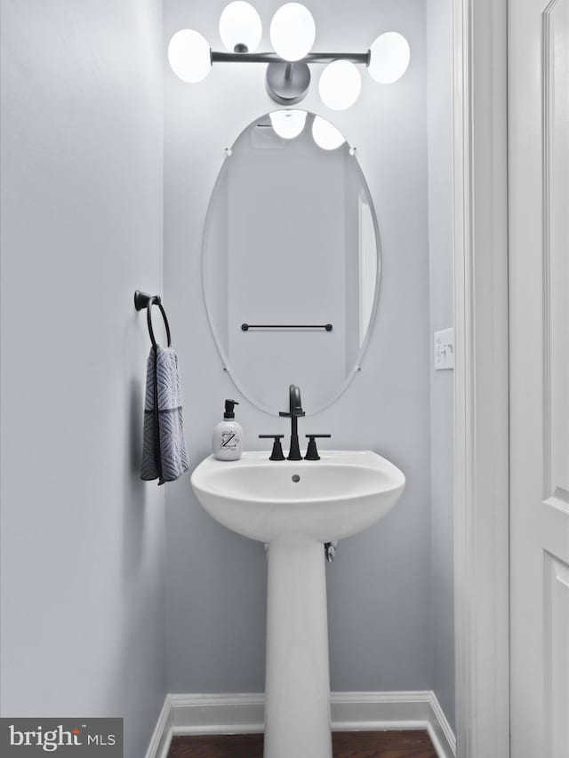 8197 Cottage Rose Ct, Fairfax Station, VA 22039 - bathroom featuring baseboards and wood finished floors