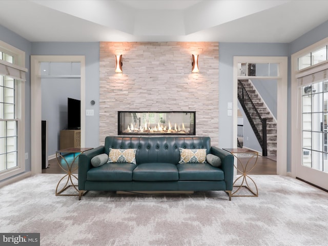 8197 Cottage Rose Ct, Fairfax Station, VA 22039 - living area featuring a multi sided fireplace, stairway, carpet floors, and baseboards