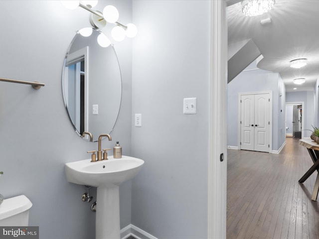 8197 Cottage Rose Ct, Fairfax Station, VA 22039 - bathroom featuring hardwood / wood-style flooring, baseboards, toilet, and a chandelier
