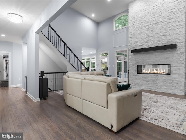 8197 Cottage Rose Ct, Fairfax Station, VA 22039 - living room with wood finished floors, a fireplace, plenty of natural light, recessed lighting, and a high ceiling