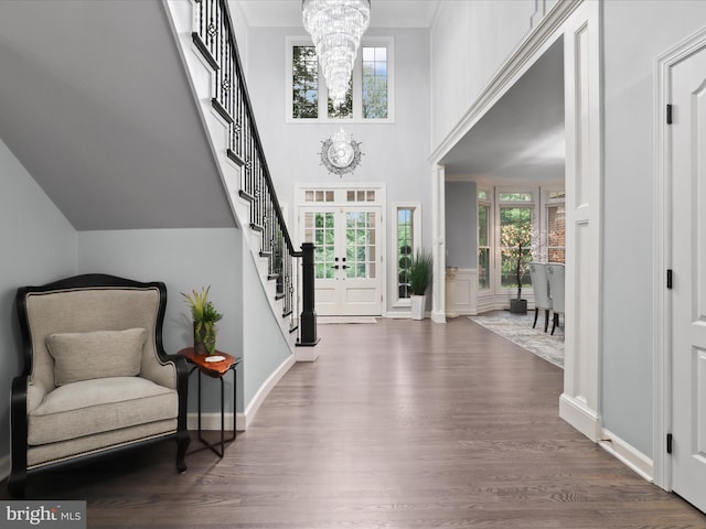 8197 Cottage Rose Ct, Fairfax Station, VA 22039 - foyer with a chandelier, stairs, wood finished floors, a decorative wall, and baseboards