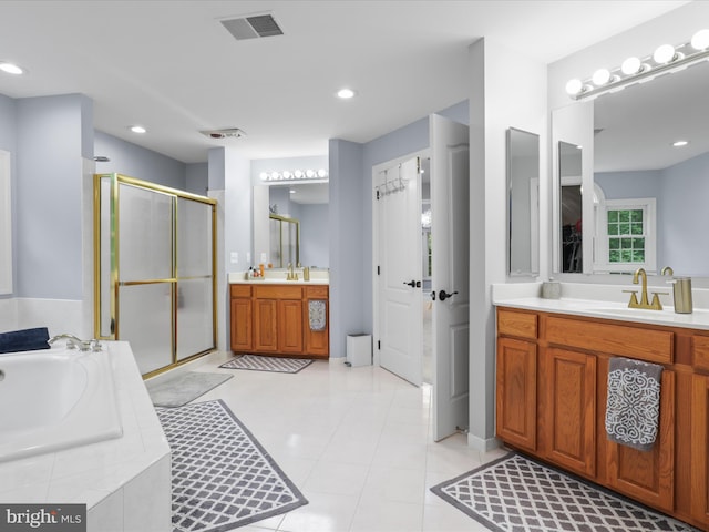 8197 Cottage Rose Ct, Fairfax Station, VA 22039 - bathroom featuring a shower stall, two vanities, a bath, and recessed lighting