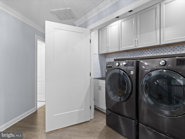 8197 Cottage Rose Ct, Fairfax Station, VA 22039 - laundry area featuring separate washer and dryer, cabinet space, crown molding, wood finished floors, and baseboards