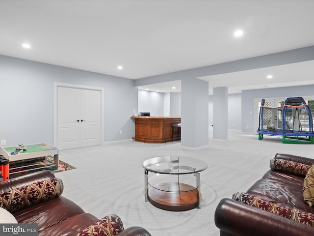 8197 Cottage Rose Ct, Fairfax Station, VA 22039 - carpeted living area featuring bar area, recessed lighting, and baseboards