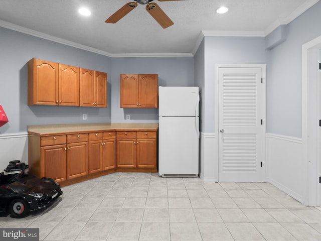 8197 Cottage Rose Ct, Fairfax Station, VA 22039 - kitchen featuring freestanding refrigerator, a ceiling fan, light countertops, crown molding, and brown cabinets