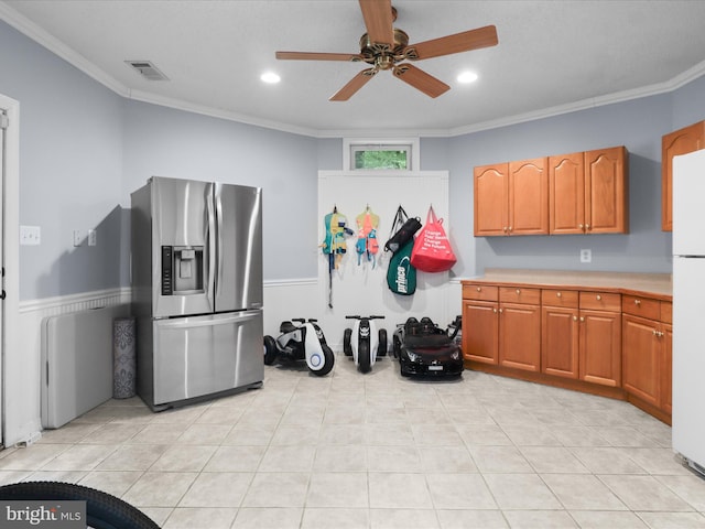 8197 Cottage Rose Ct, Fairfax Station, VA 22039 - kitchen featuring stainless steel refrigerator with ice dispenser, ornamental molding, a ceiling fan, light countertops, and a wainscoted wall