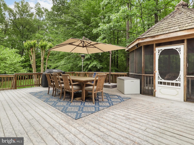 8197 Cottage Rose Ct, Fairfax Station, VA 22039 - deck with outdoor dining area, a sunroom, view of scattered trees, and area for grilling