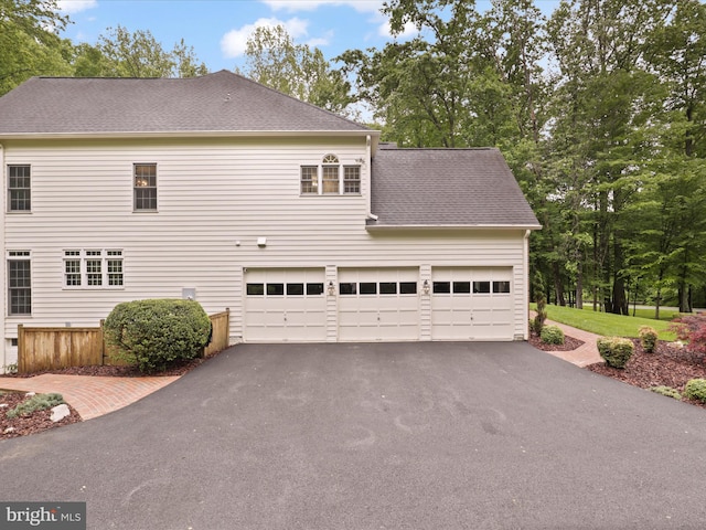 8197 Cottage Rose Ct, Fairfax Station, VA 22039 - view of side of home featuring asphalt driveway and roof with shingles