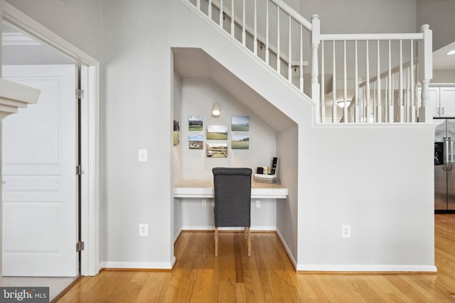 12001 Market St Unit 441, Reston, VA 20190 - corridor with wood finished floors, a desk, baseboards, and stairs