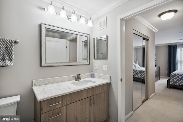 12001 Market St Unit 441, Reston, VA 20190 - ensuite bathroom with ornamental molding, vanity, toilet, and baseboards