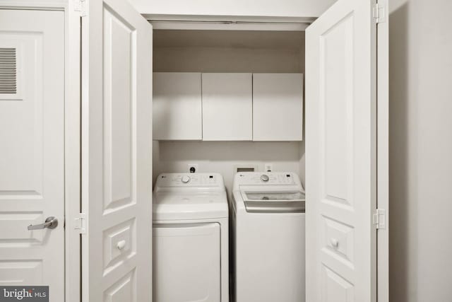 12001 Market St Unit 441, Reston, VA 20190 - laundry area with cabinet space and washer and clothes dryer