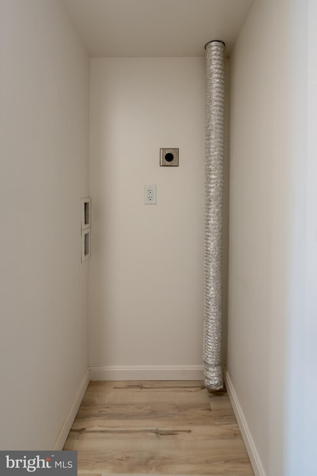 laundry room with hookup for an electric dryer, light wood finished floors, baseboards, and hookup for a washing machine