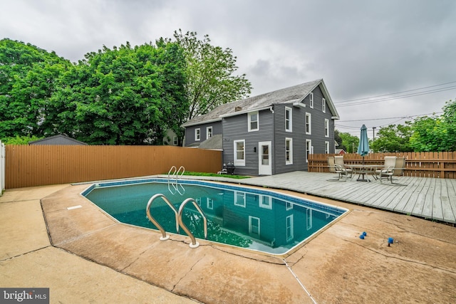 view of pool featuring a deck and a fenced backyard