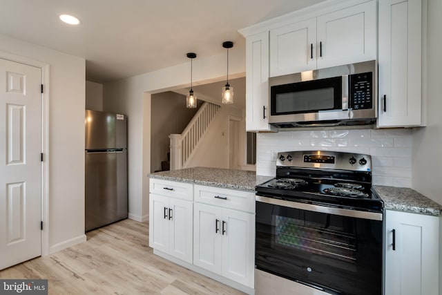 kitchen featuring stainless steel appliances, backsplash, white cabinets, light wood-style flooring, and recessed lighting