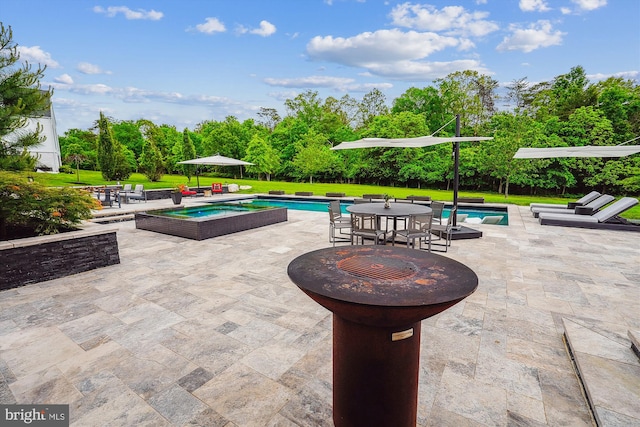 swimming pool featuring a patio area, a lawn, view of scattered trees, and outdoor dining area