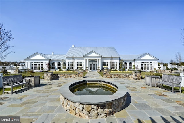 surrounding community featuring a patio area and a jacuzzi