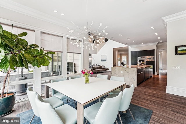 dining room with dark wood-type flooring, a chandelier, crown molding, recessed lighting, and baseboards